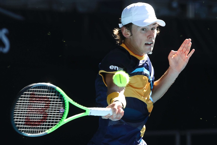Alex de Minaur plays a forehand at the Australian Open.