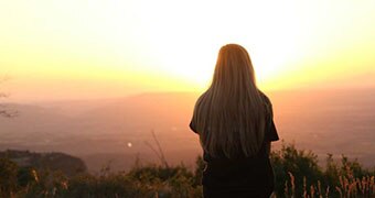 Woman looking at the sunset.