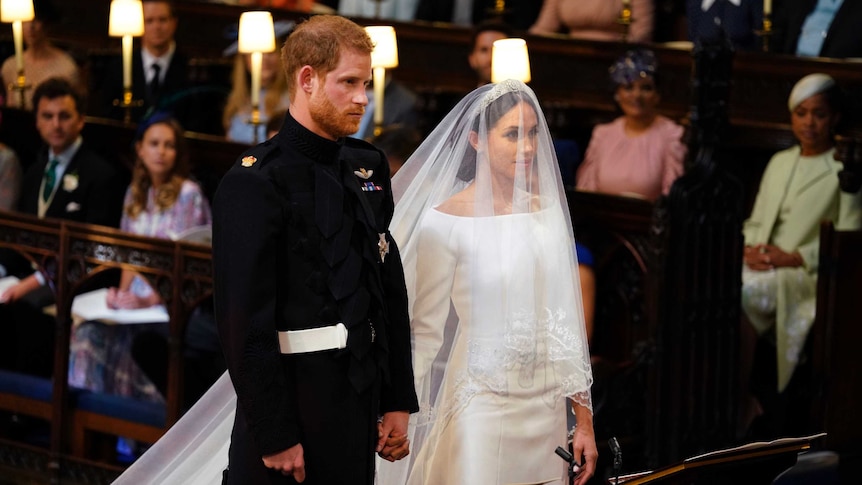 Britain's Prince Harry and Meghan Markle stand, prior to the start of their wedding ceremony.