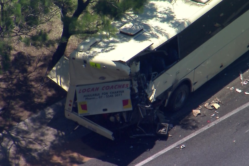 The back of a bus smashed in after a crash.