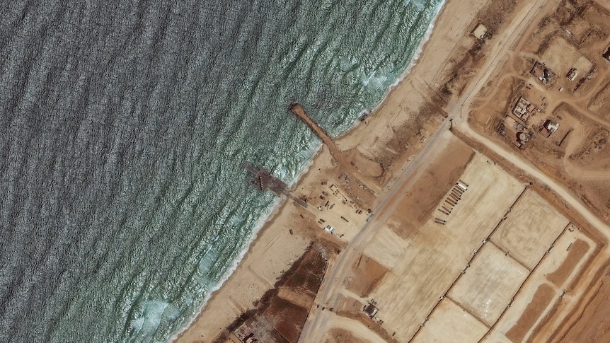 Satellite image of the sea and a pier. 