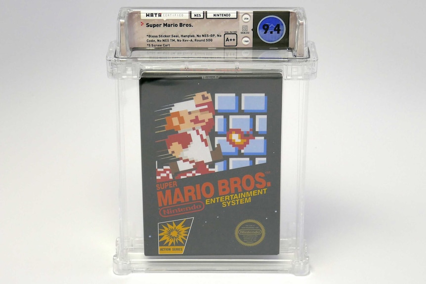 The sealed copy of Super Mario Bros inside a clear plastic display.