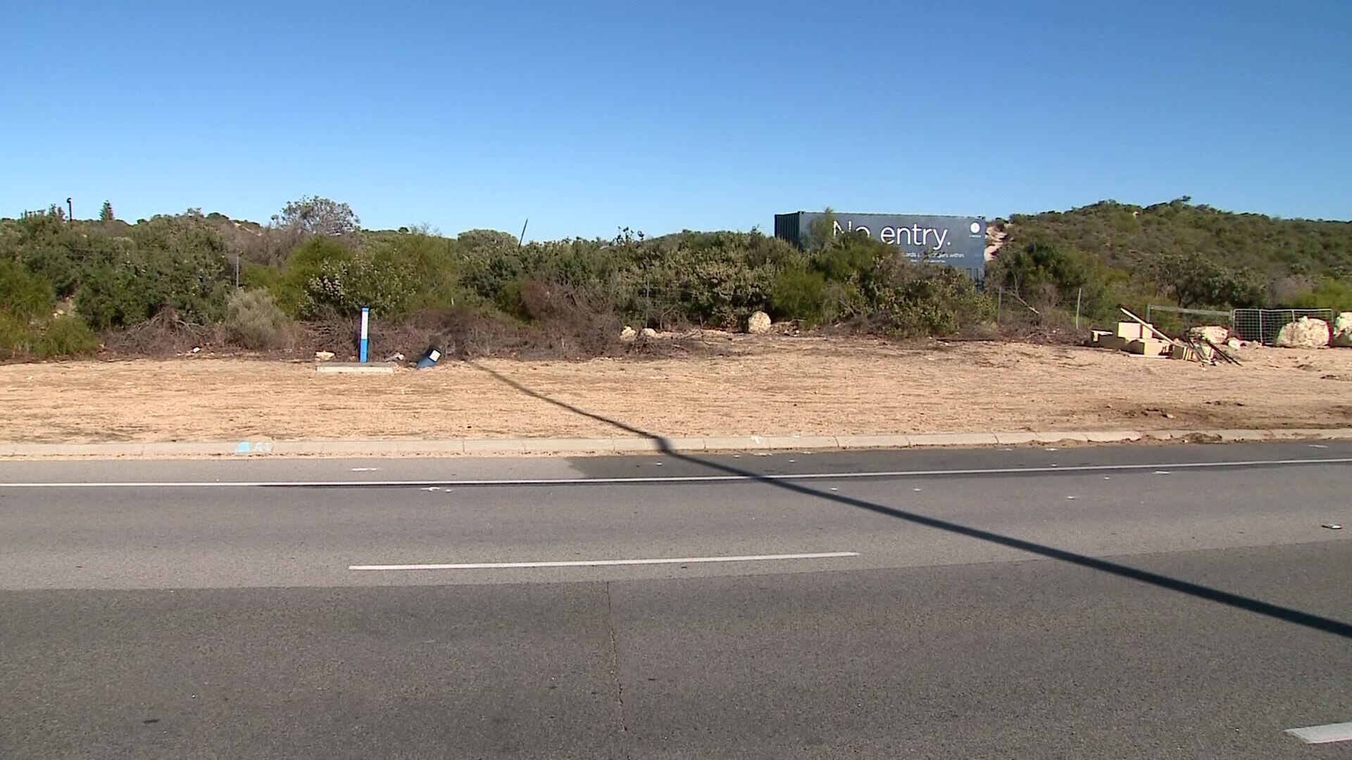 A suburban road runs along the coast 