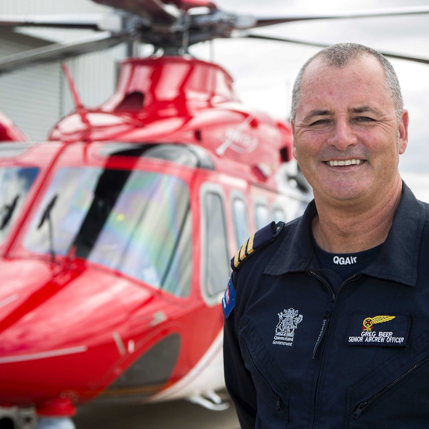 Greg Beer, Senior Aircrew Officer at QGAir, standing in front of an AW 139 rescue chopper.
