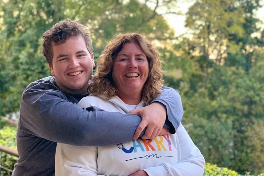 Maria Smith with her son Isaak's arms around her