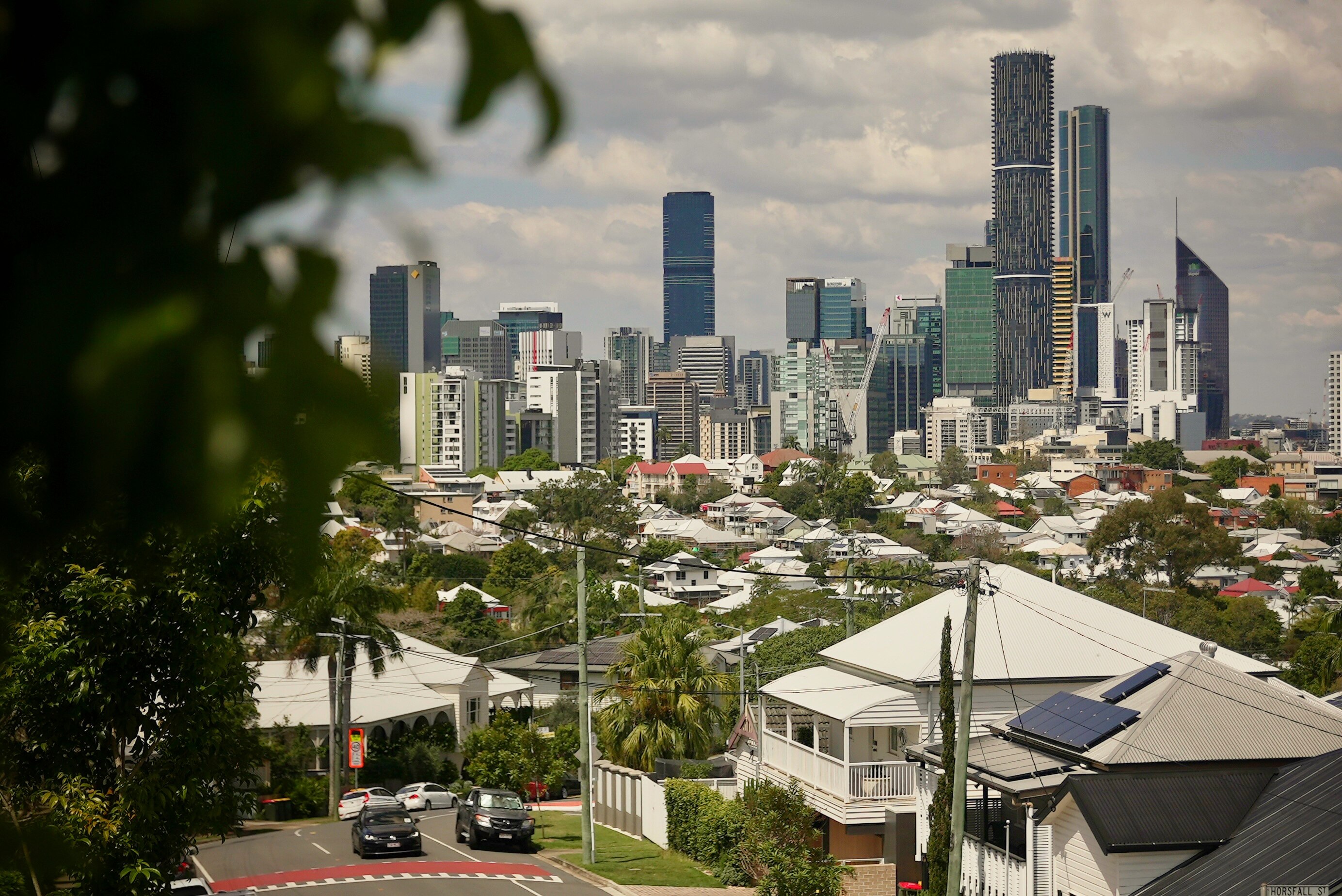 Queenslanders in the foreground with Brisbane City in the background.