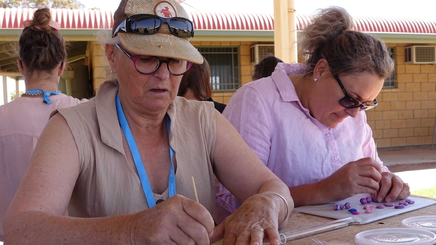 Robyn Caldwell, from remote western Queensland, poking a pattern into polymer clay beads