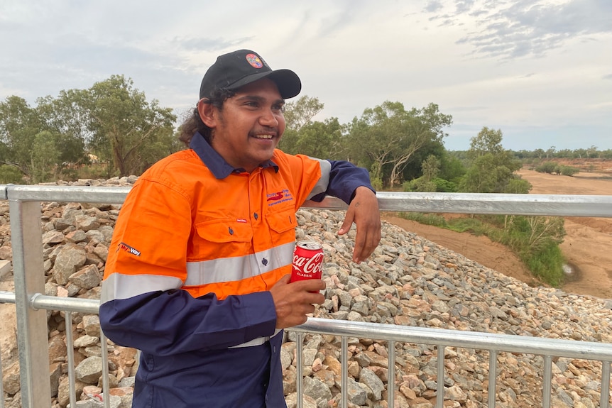 man in high-vis sntads on bridge