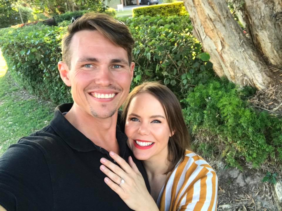 Ryan and Stacey Quinn pose for a selfie showing off her engagement ring for a story about what to do before buying a home.
