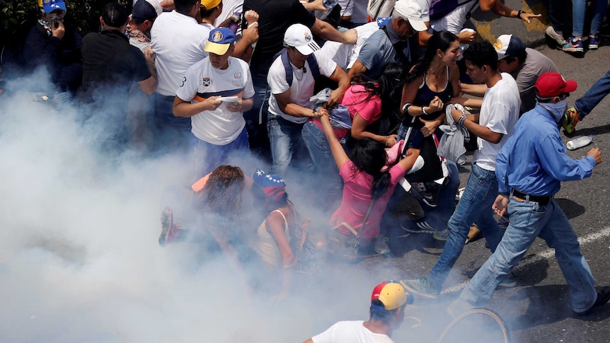 Demonstrators clash with police during a massive protest in Caracas, Venezuela.