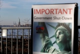 A sign announcing the closure of the Statue of Liberty sits near the ferry dock at Battery Park