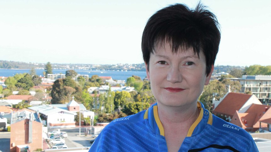 Western Force member and fan, Alison Foskett, standing on a balcony with the Swan River behind her