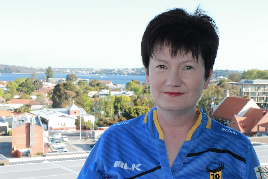 Western Force member and fan, Alison Foskett, standing on a balcony with the Swan River behind her