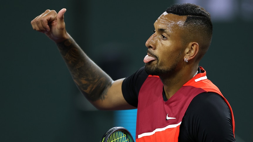 An Australian male tennis player makes a motion with his right hand during a match in Indian Wells.