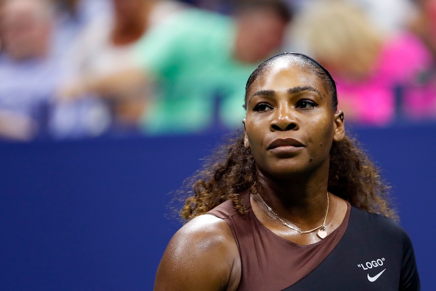 Serena Williams looks into the distance with a dead-pan expression on her face