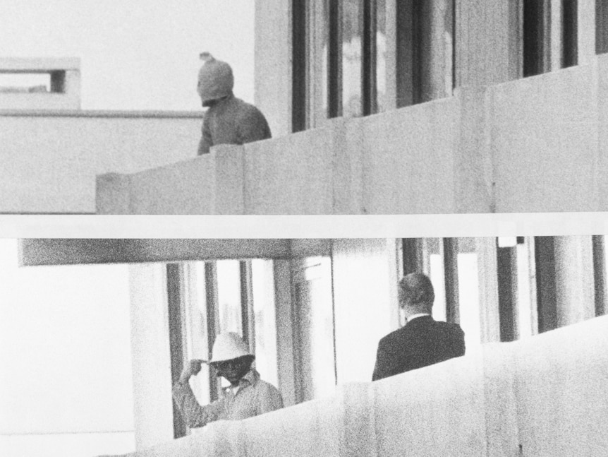 A double photo of a masked terrorist on a balcony, and a hatted terrorist on a below balcony.