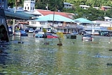 Water floods the street of a town in American Samoa in the wake of the tsunami