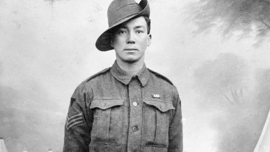 A black and white photo of a man in a World War I soldier's uniform
