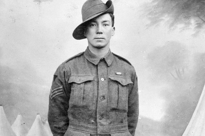 A black and white photo of a man in a World War I soldier's uniform