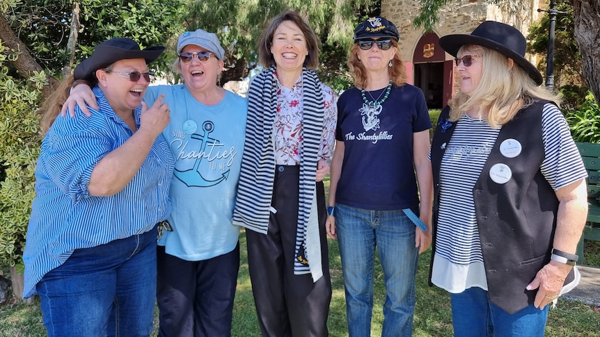 Five women laughing and smiling.