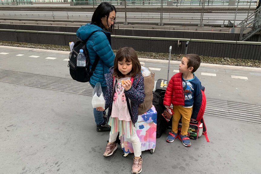 Junko, Juna and Remy waiting for a train in Amsterdam with their luggage.