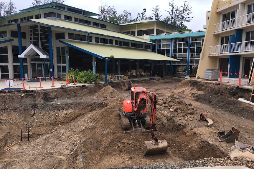 A bulldozer in a hole on a construction site