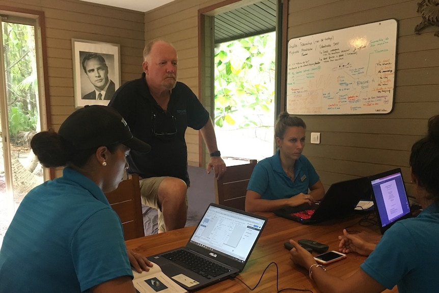 Frank Murphy and several Tetiaro Society staff at the not-for-profit's headquarters, a picture of Marlon Brando on the wall