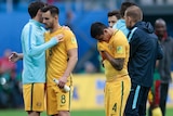 Socceroos players are sad after Cameroon draw.