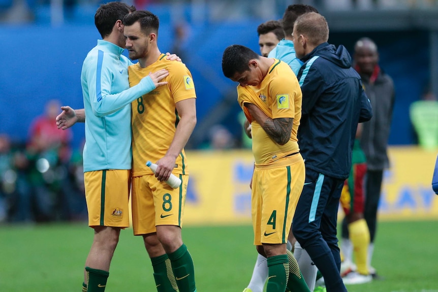 Socceroos players are sad after Cameroon draw.