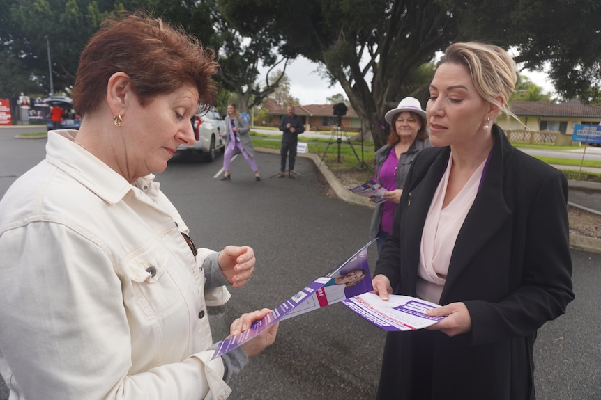 Politician Hayley Edwards talking to a woman. 