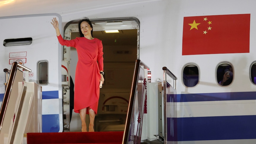 A woman in red dress walking out of an aircraft