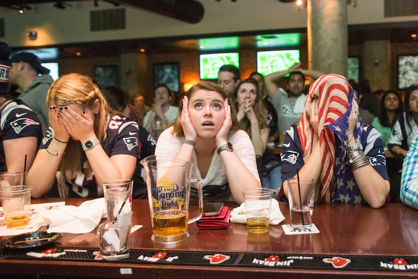 New England Patriots fans react to a Seattle Seahawks touchdown during the second quarter in Super Bowl XLIX