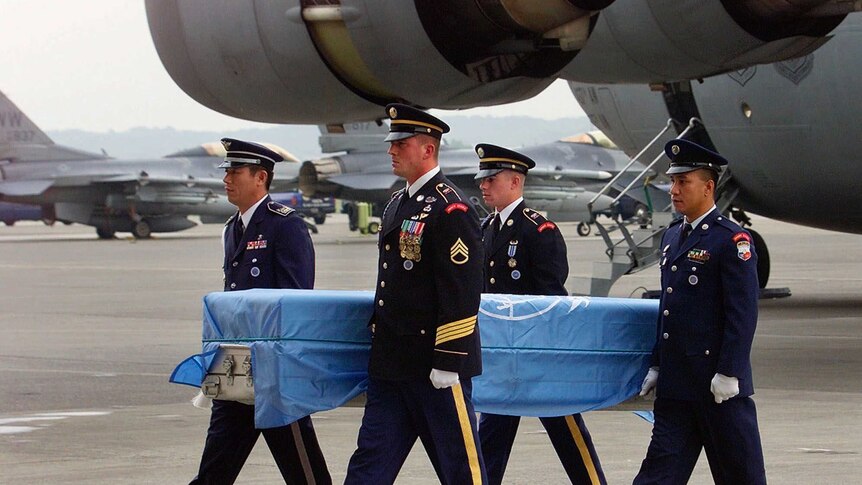 United Nations' soldiers carries a coffin of a missing US soldier's remains in 2000.