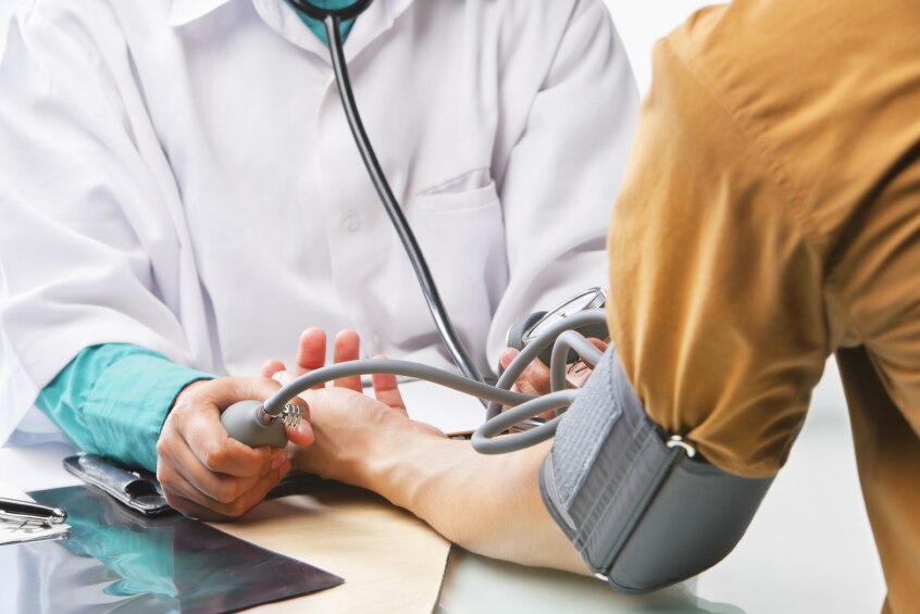 A doctor taking a patient's blood pressure.