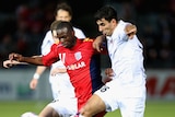 Tight contest ... Bruce Djite (L) is challenged by Artyom Filiposyan