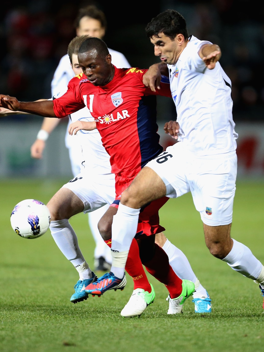 Tight contest ... Bruce Djite (L) is challenged by Artyom Filiposyan