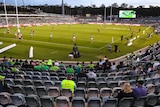 NRL fans can be seen looking at the action, with plenty of empty seats in the stands.