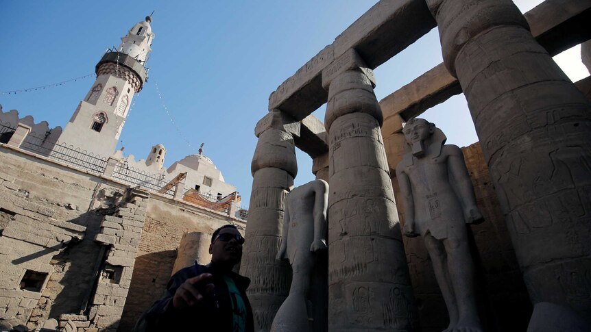 A tour guide is seen in front of Abu El-Hagag mosque in Luxor.