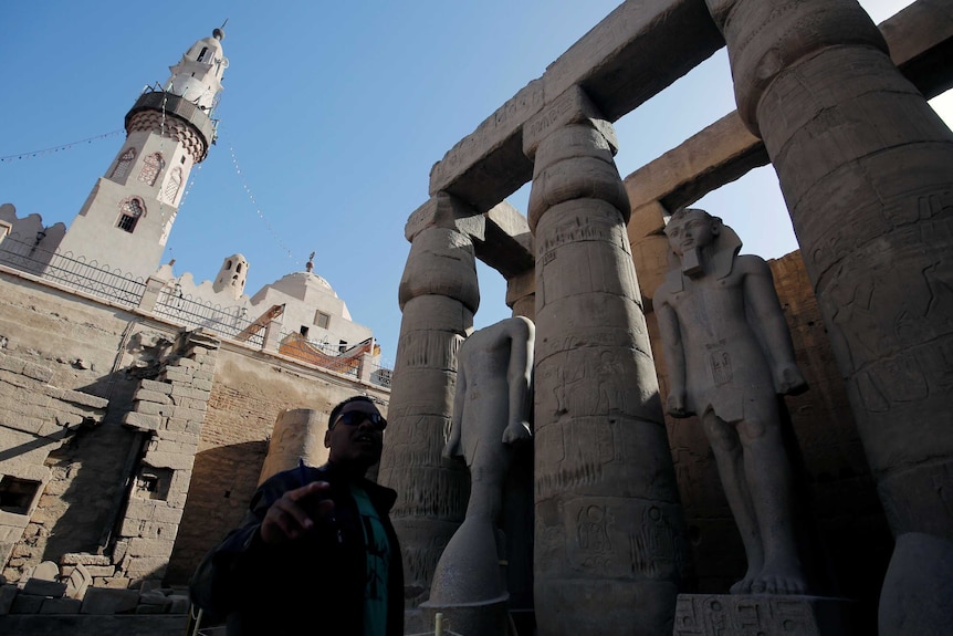 A tour guide is seen in front of Abu El-Hagag mosque in Luxor.
