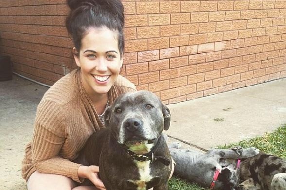 Candice Locke smiling with three dogs