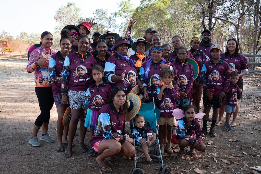 A group of indigenous people from Napranum smile at the camera