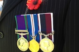 Close up of service medals and red poppy
