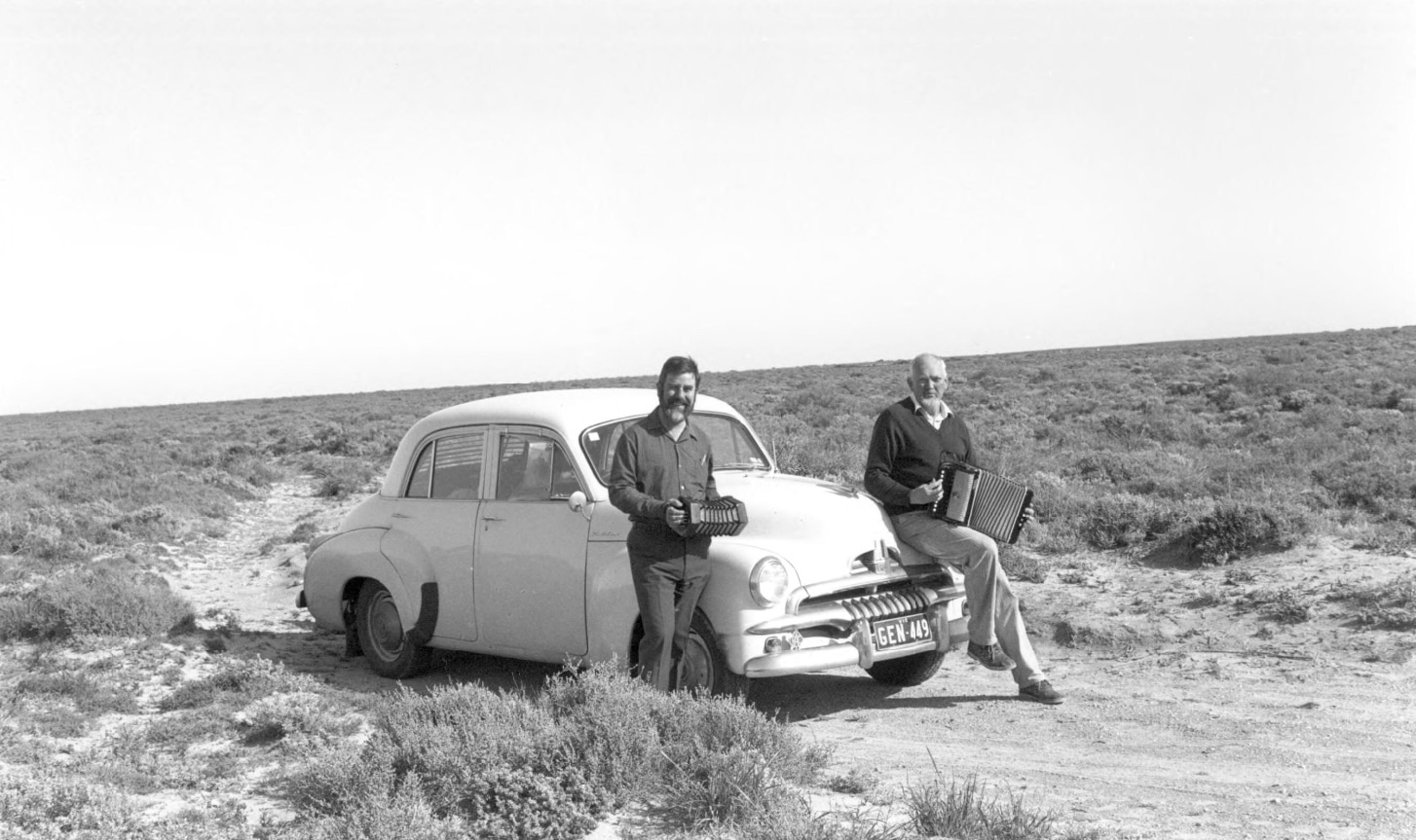 Peter Ellis and John Meredith on the Nullarbor plain sitting on their FJ Holden in 1991