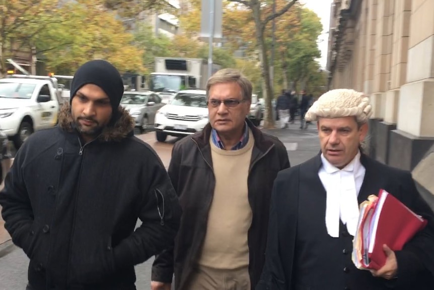 Mohamed Siddique (C) walks outside the Court of Appeal.