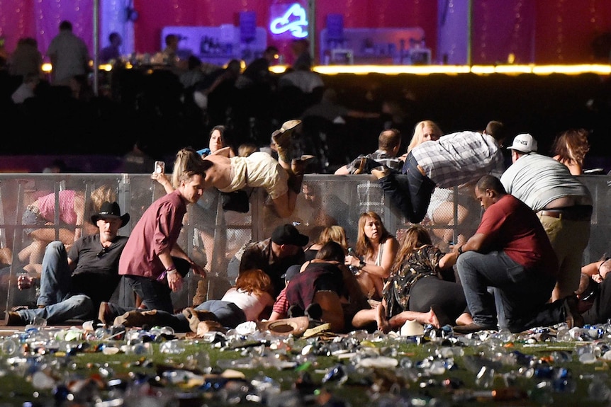 People scramble for shelter at the Route 91 Harvest country music festival