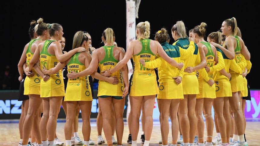 A group of netball players huddle up after a loss