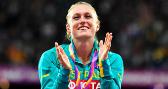 Sally Pearson tears up and claps at the medal ceremony for the 100m hurdles.