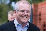 Prime Minister Scott Morrison smiles as he walks in to a child care centre.