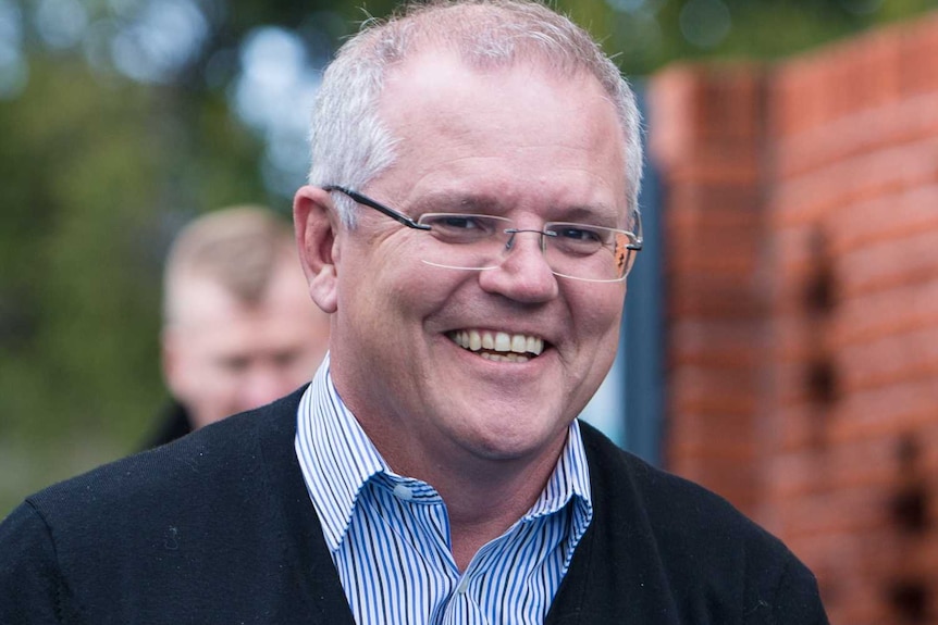 Prime Minister Scott Morrison smiles as he walks in to a child care centre.