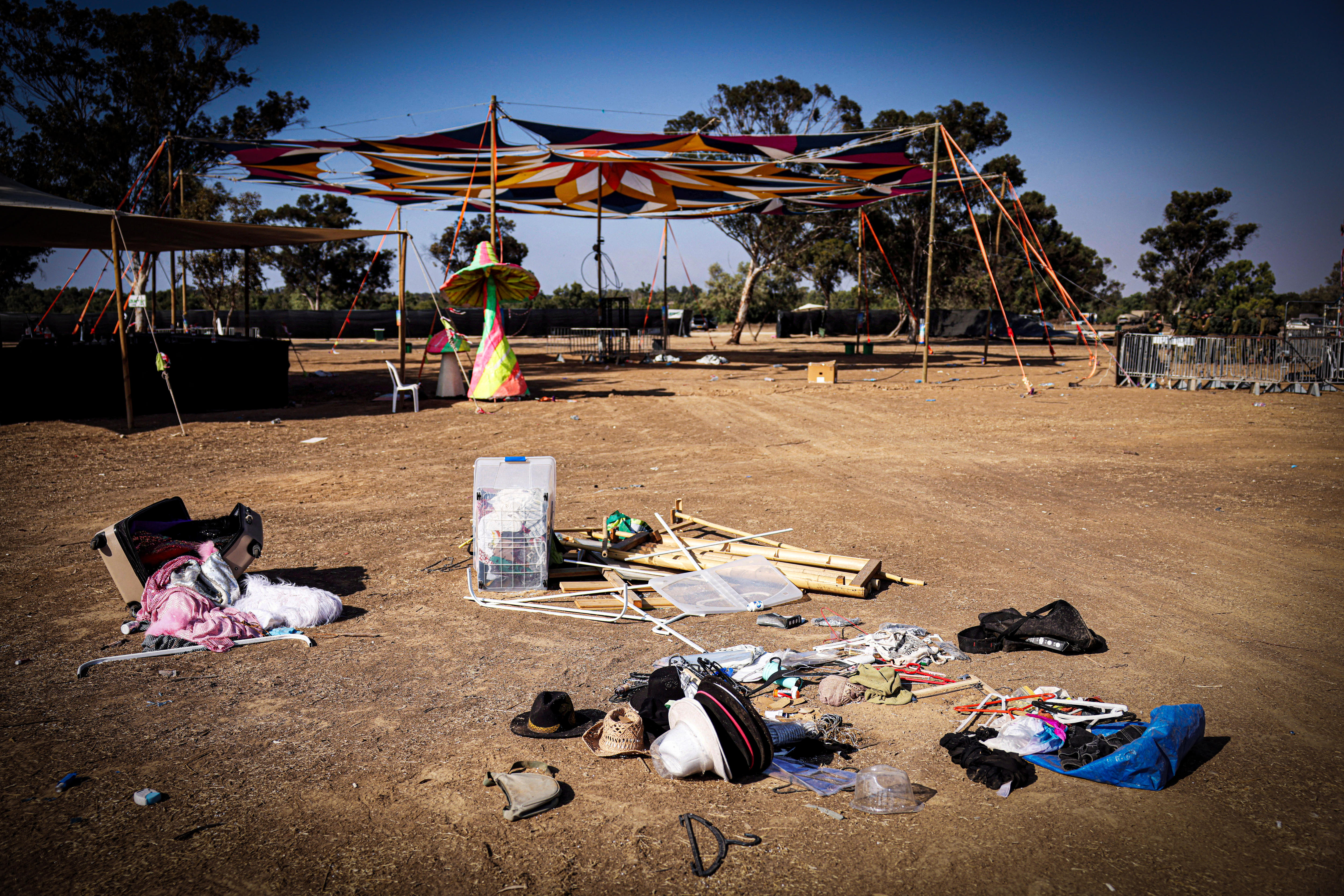 Hats and other objects left in a sandy field